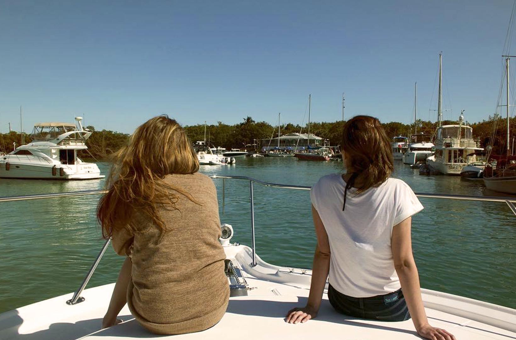 image of friends sitting on a boat